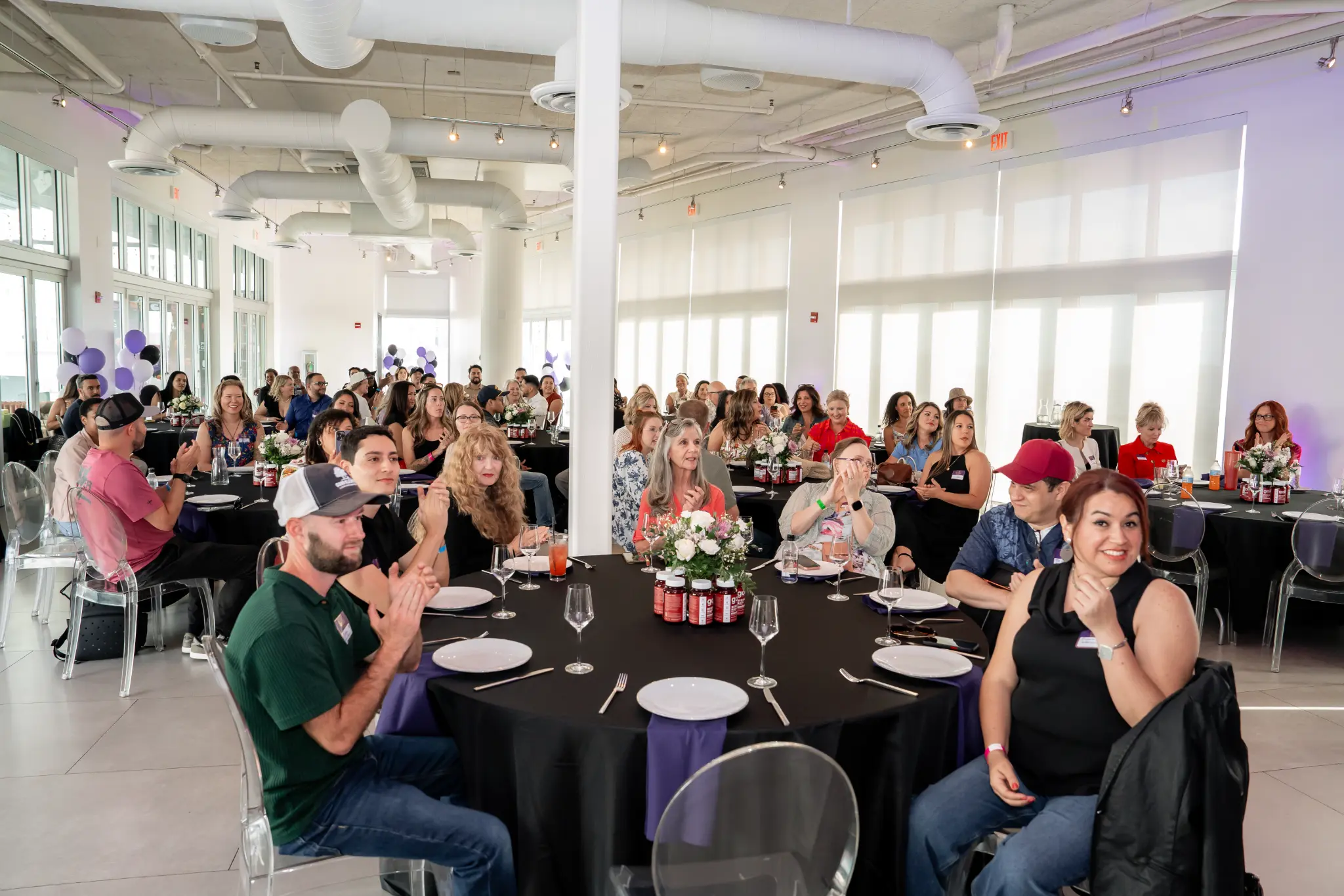 Creators seated at round tables at a previous 6FC event